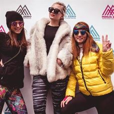 three girls posing with Minus Zero branded backdrop